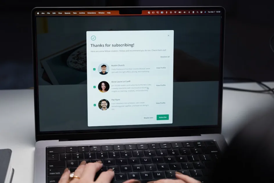 a woman is typing on a laptop keyboard