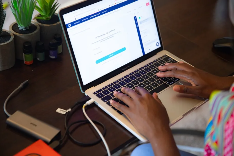 a woman using a laptop computer on a desk