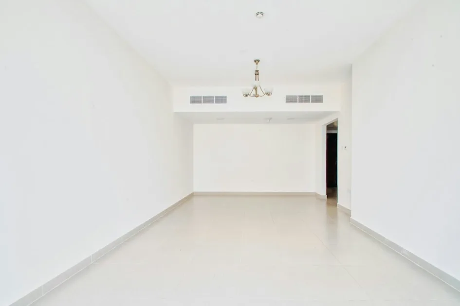 Empty room with white walls and a chandelier